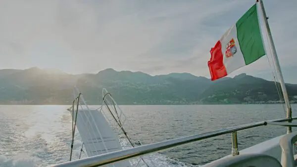 a flag on a boat in the water