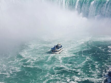 ship on body of water near falls